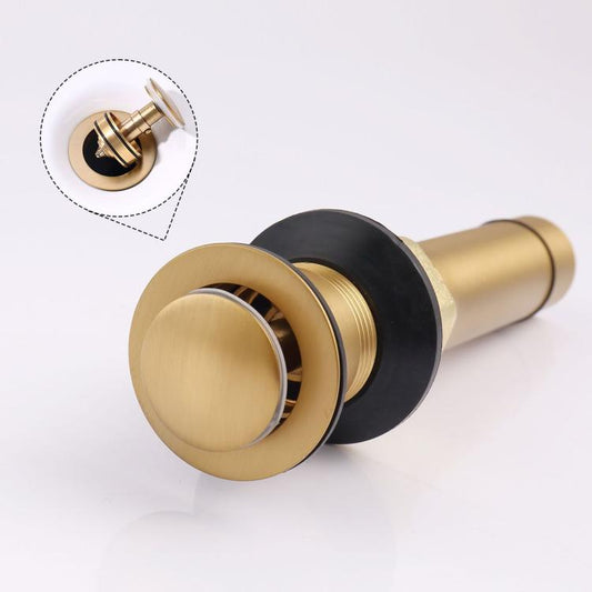 Brushed gold pop-up drain stopper with circular face and black underside