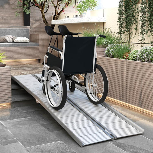 Aluminum wheelchair ramp over steps with ribbed non-slip surface and side rails