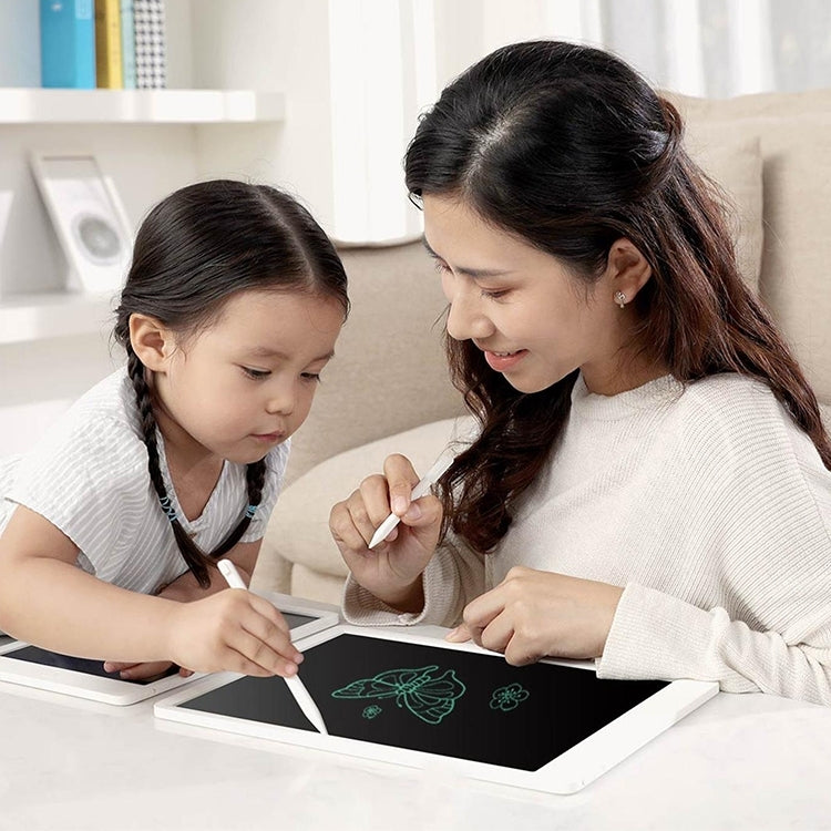 Two people drawing on a 20-inch LCD writing tablet with stylus pens