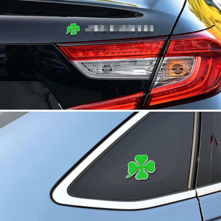 Four-leaf clover sticker on a car panel near the rear tail light trim