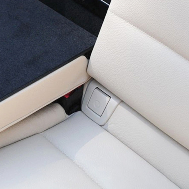 Beige ISOFIX switch cover installed on car seat near ISOFIX button