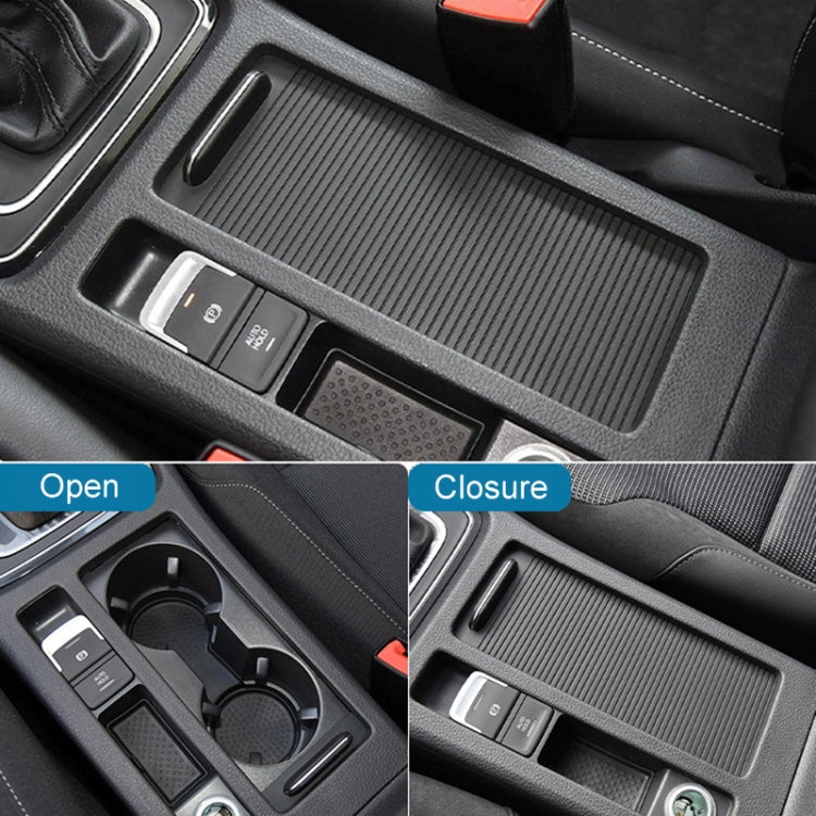 Textured dark cup holder cover showing open and closed positions in center console