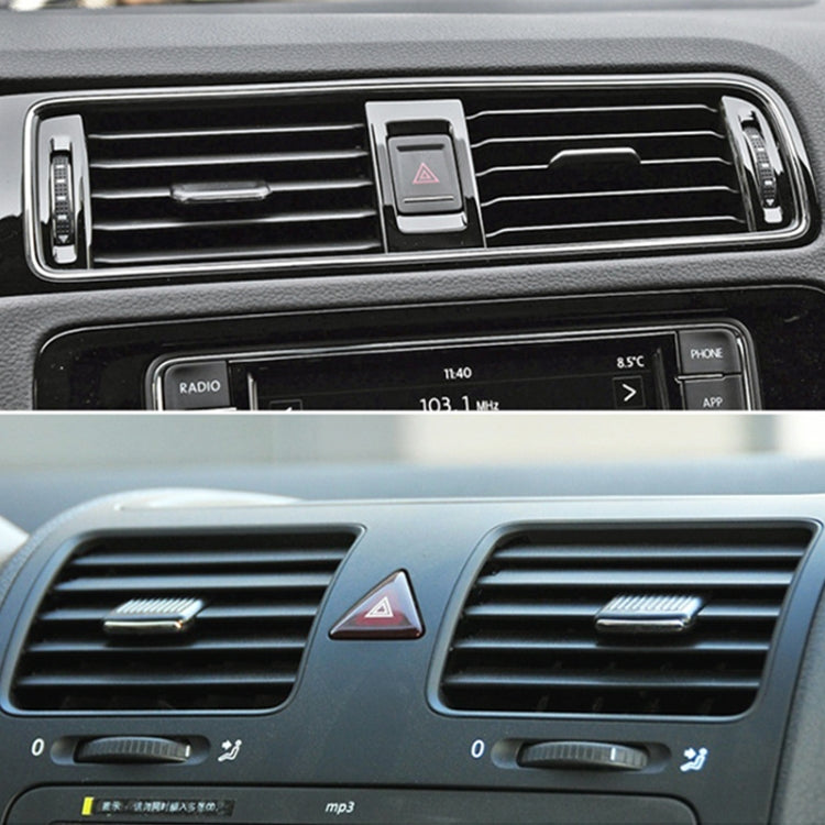 Installed black AC air vent paddle on dashboard, center-left position