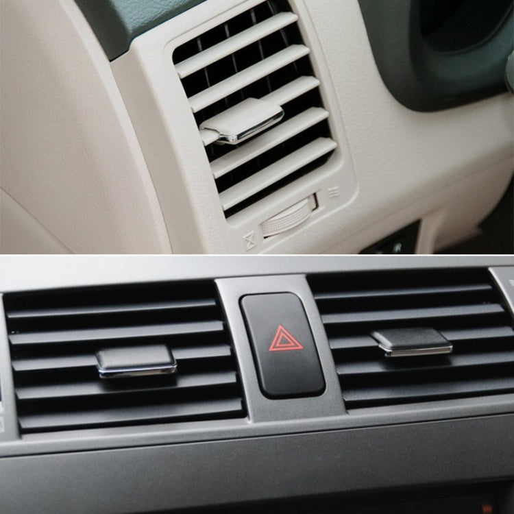 Dashboard air vent with black middle adjustment paddle and red hazard icon
