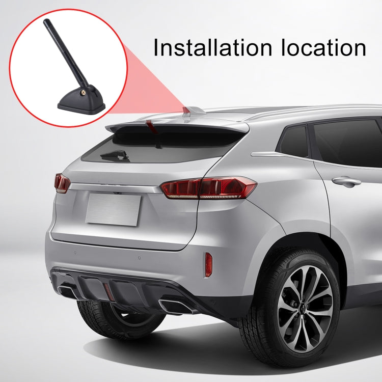 Car with black roof antenna mast installed on rear roof panel