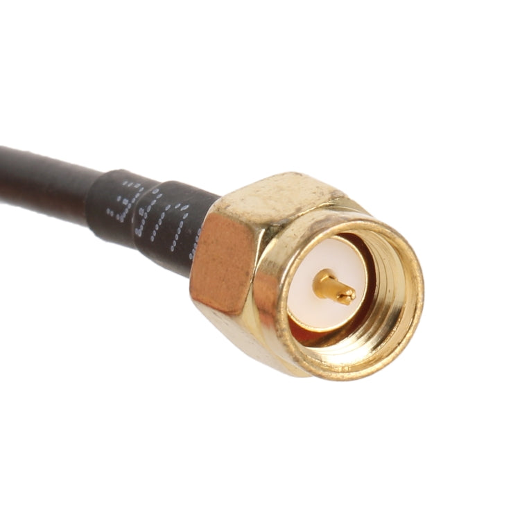 Close-up of gold SMA male connector on an IEC-to-SMA adapter cable, black cable.