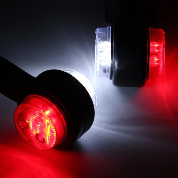 Lit LED side marker lights with red and white round lenses on black housings