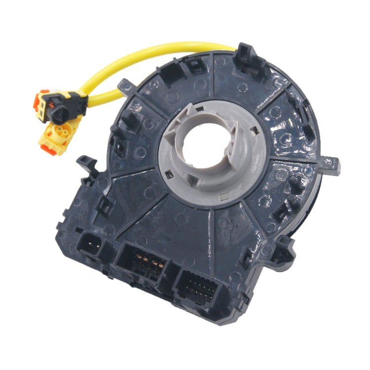 Clock spring spiral cable assembly with yellow wires and circuit-board ports, dark plastic