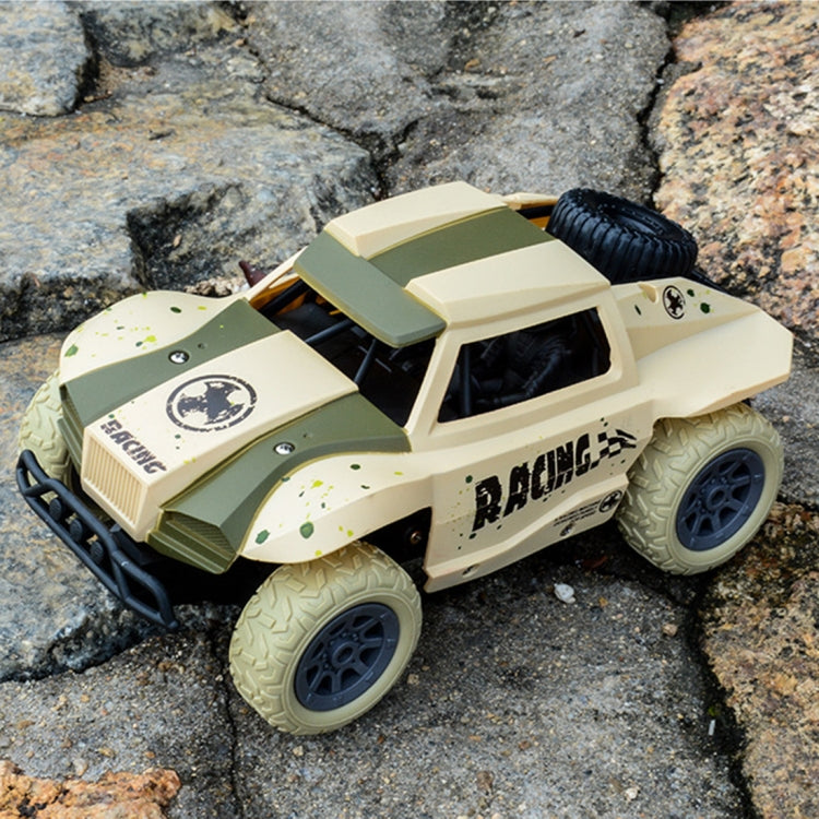 Cream and olive remote control off-road truck toy on rocks with chunky tread tires