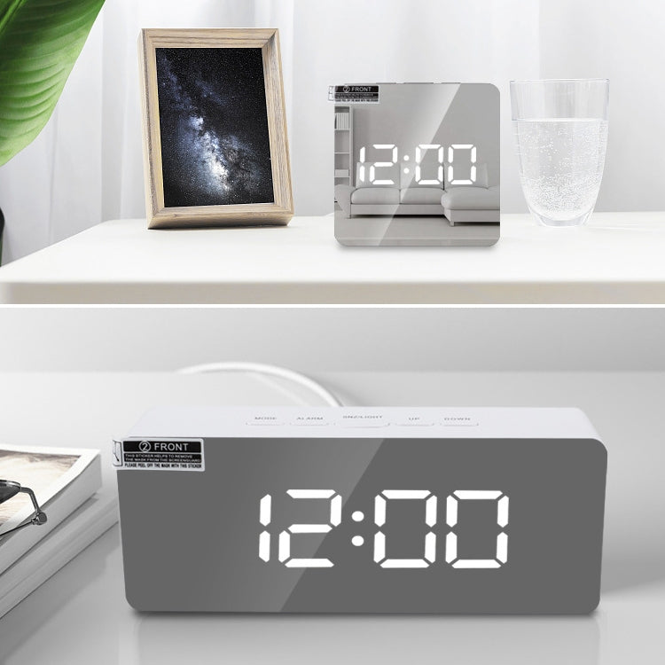 LED mirror alarm clock close-up, dark display window with large white LED numbers