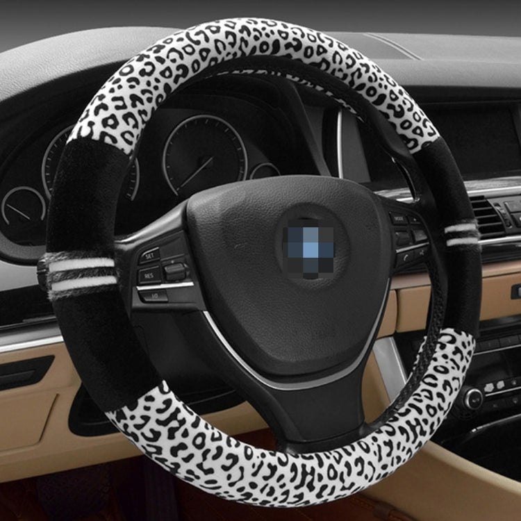 Leopard-print steering wheel cover with white-and-black spots and black striped grip bands