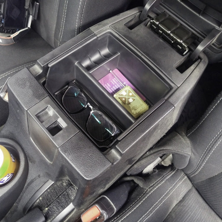 Black car storage organizer box in console with two compartments holding cards and sunglasses