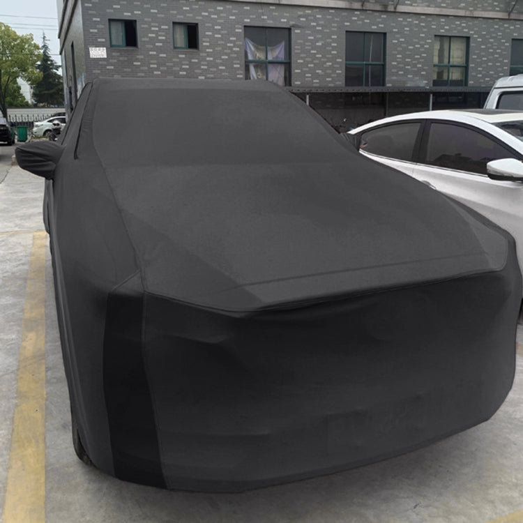 Black fitted sedan car cover draped over vehicle