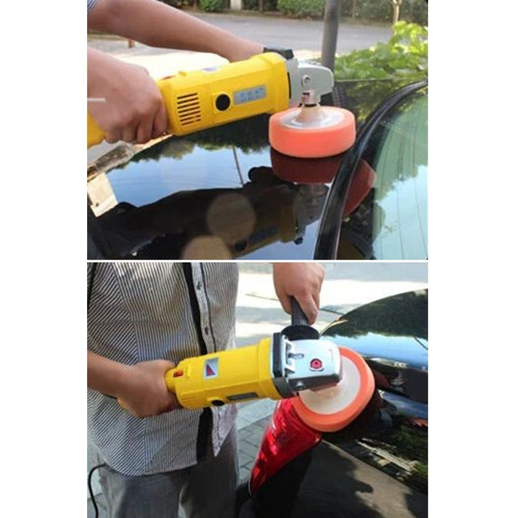 Orange polishing sponge wheel attached to a handheld polisher for car surface finishing.