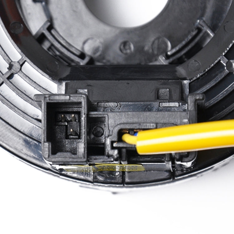 Clock spring contact housing with yellow wire plugged into black connector