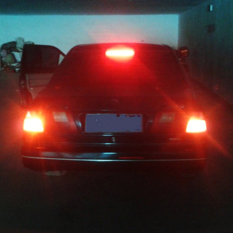 Car with red brake and tail lights illuminated by LED bulbs