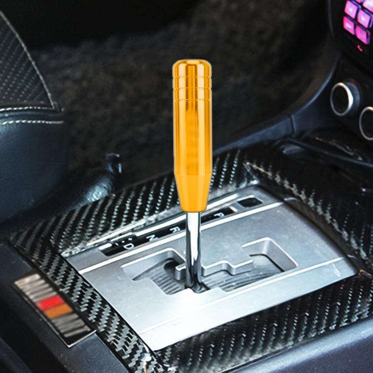 Universal long gear shift knob with gold cap on shifter lever