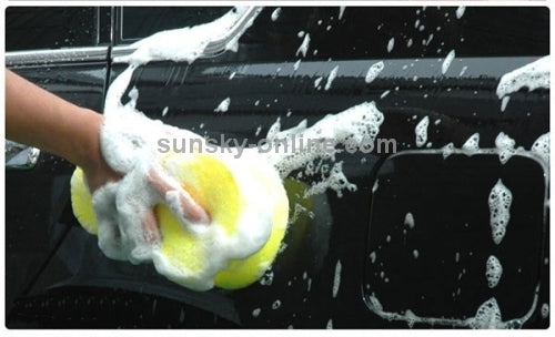 Yellow small-pore sponge scrubbing a wet car surface with foam