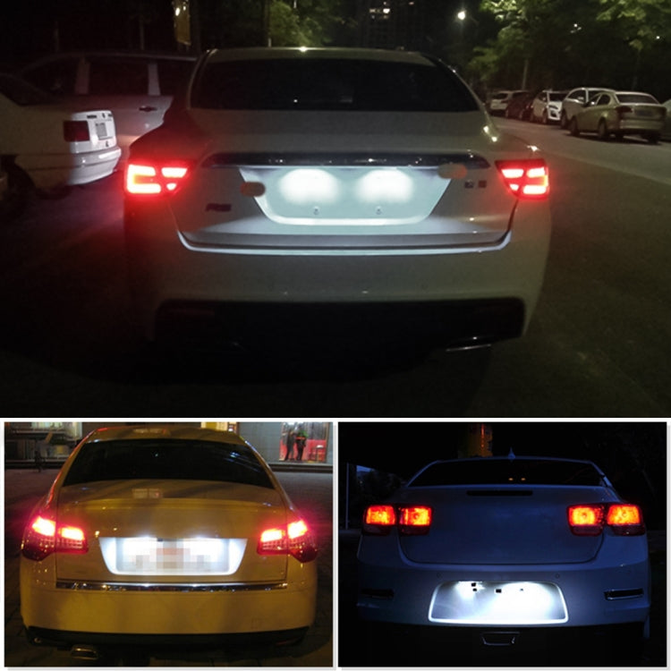Car rear view showing illuminated LED license plate lights with red tail lights