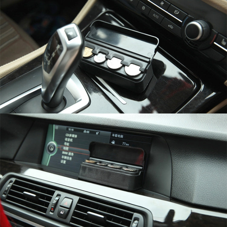 Black coin holder set in a car center console cup area, lid closed