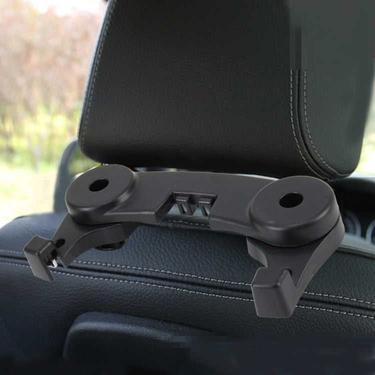 Black universal car seat back hook holder mounted on leather headrest