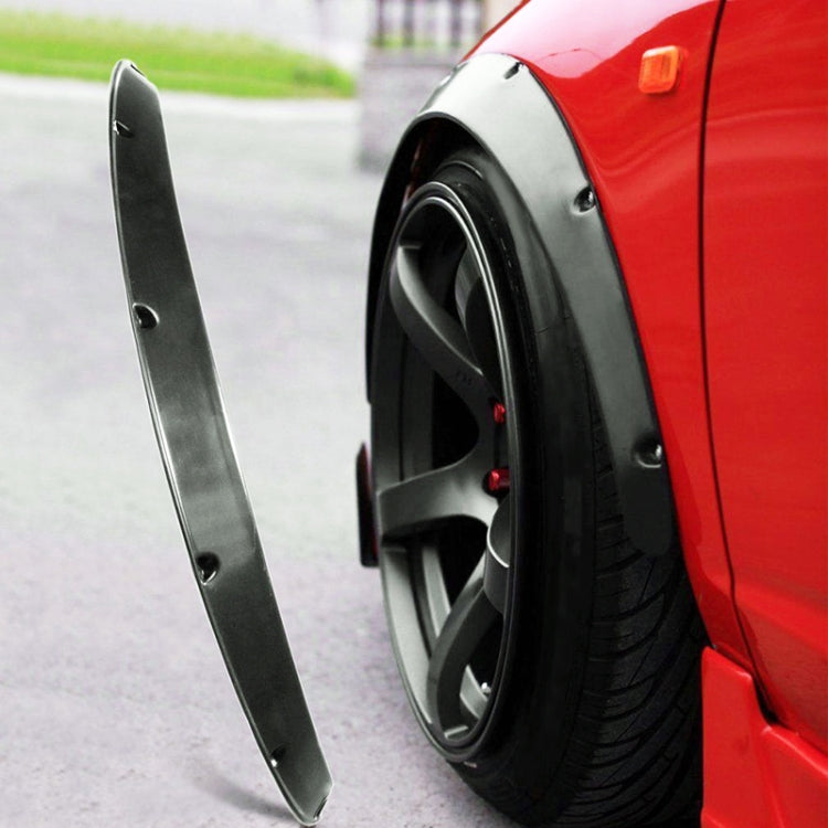 Single black unpainted wheel fender flare installed along the wheel arch