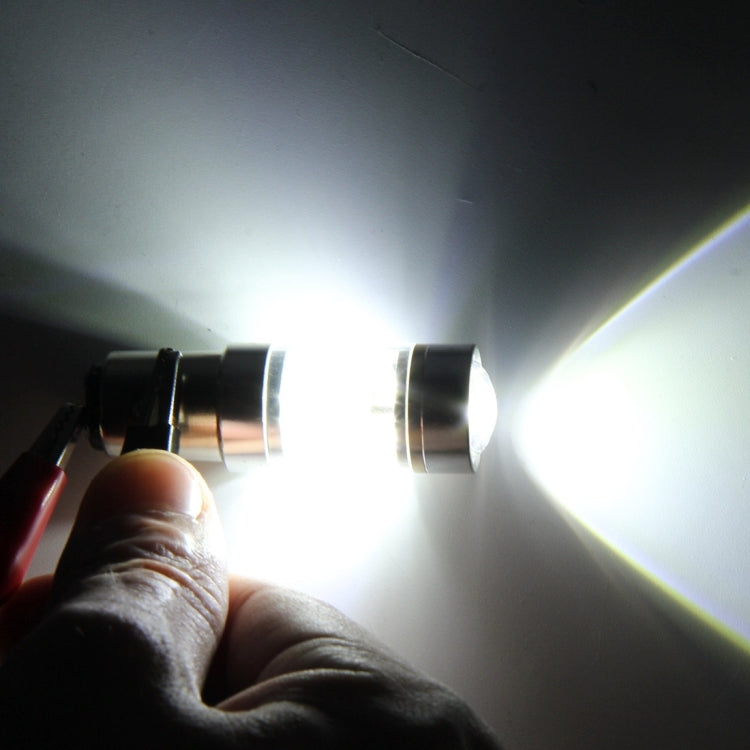LED car light bulb shining bright white, visible beam from the clear lens