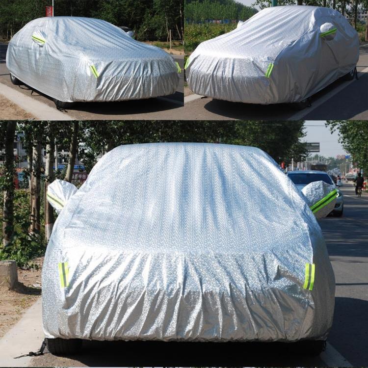 Two light gray SUV car covers on parked cars with green warning-strip accents