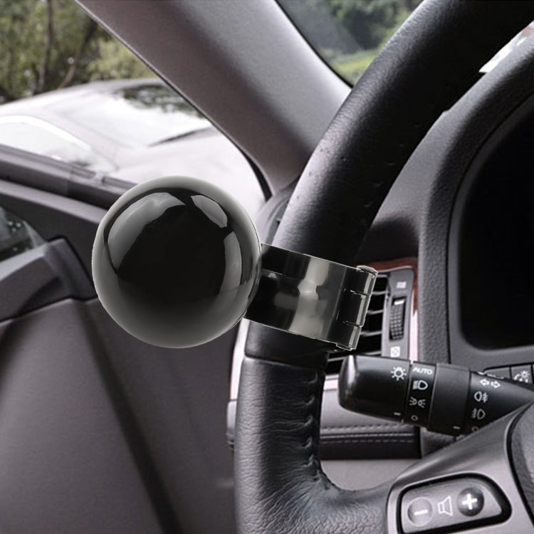 Black steering wheel spinner knob installed on car steering wheel