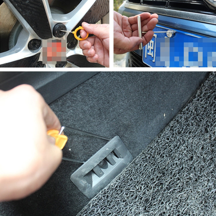 Orange trim removal tool prying a car panel near vents and fasteners