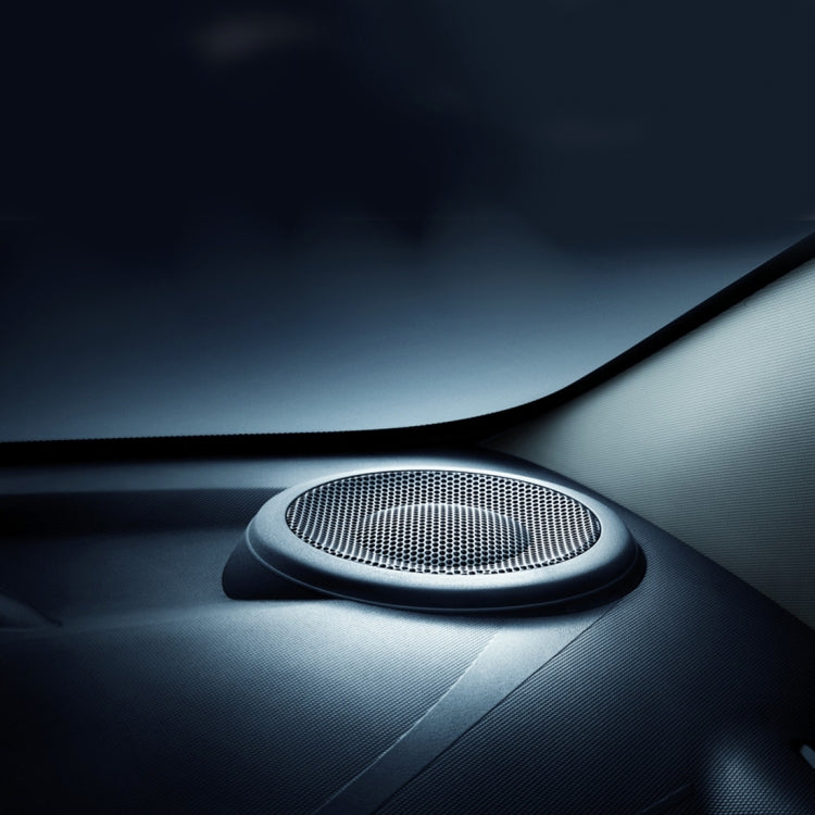 Black round horn cover installed on a car dashboard near the speaker grille