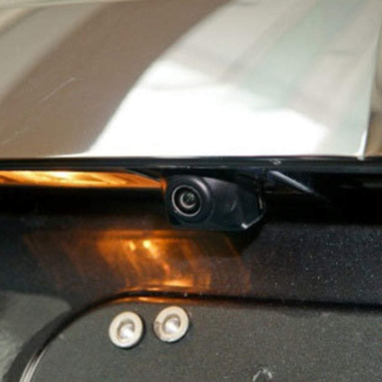 Backup camera installed at car rear under the bumper, with visible lens and wiring