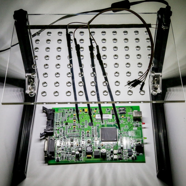 LED BDM test frame with probe arms and perforated contact board over a green ECU PCB