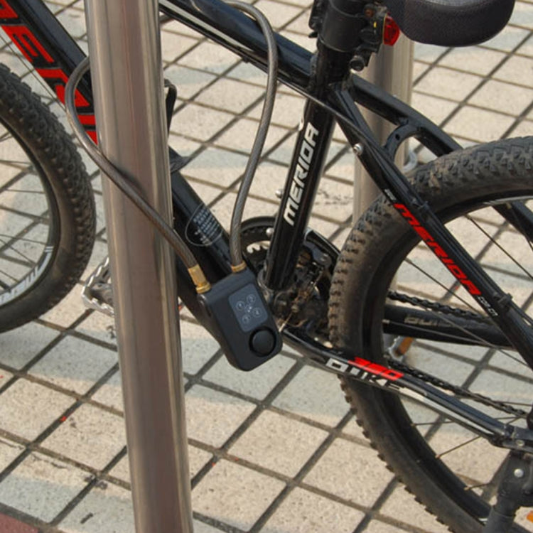 Bicycle-mounted blue vibration alarm with coiled sensor cable on frame