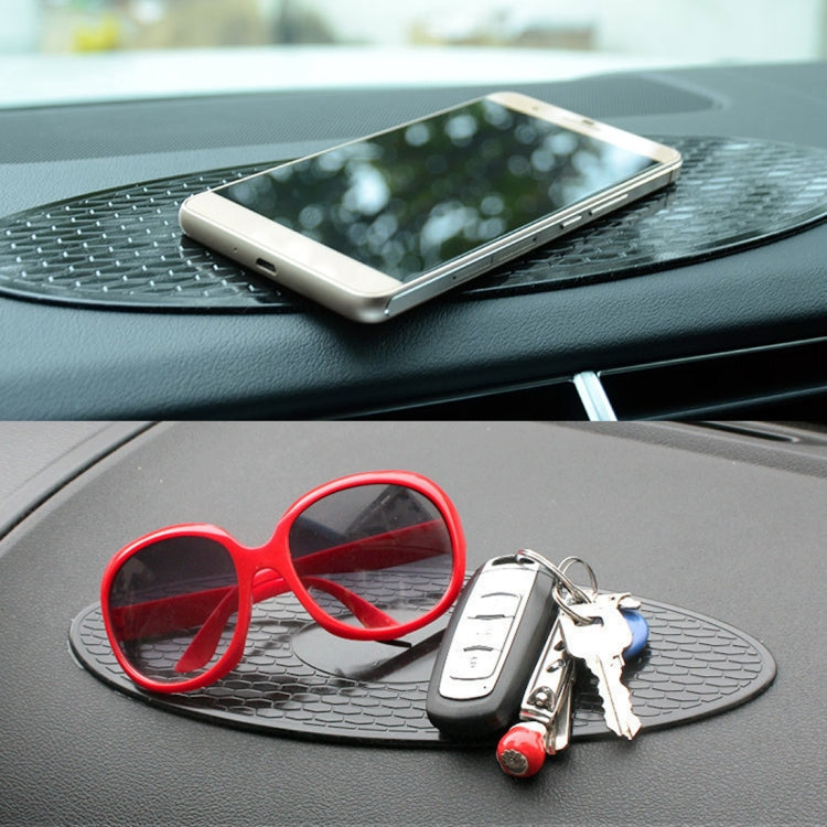 Oval anti-slip rubber dashboard mat with glasses and keys on textured grip surface