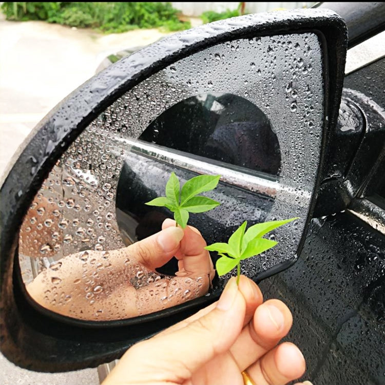 Clear anti-fog rearview mirror protective film on a round car mirror, with droplets