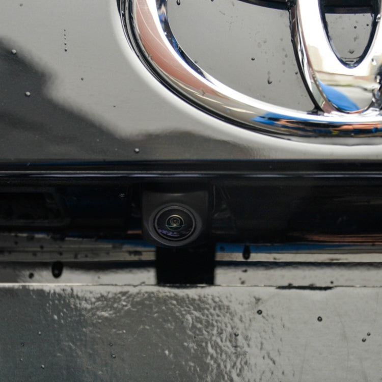 Rear bumper backup camera mounted under the license area, black lens housing