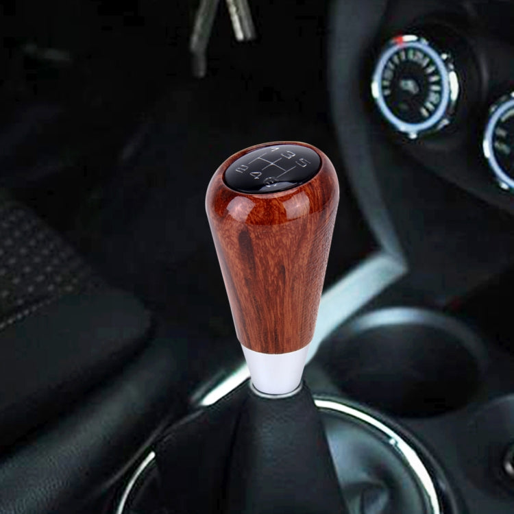 6-speed manual shifter knob, brown woodgrain resin with silver base and gear markings