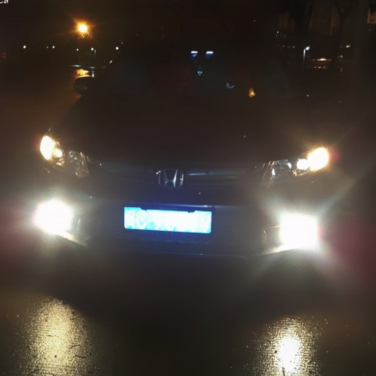 Car fog lights on with bright white illumination and glowing front lamp housings