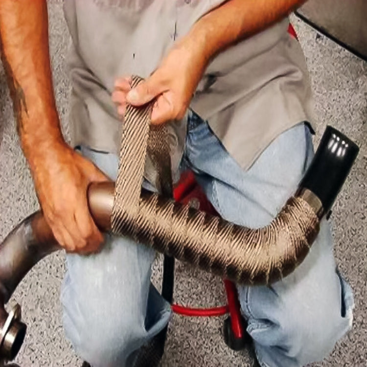 Hand applying gold exhaust heat shield wrap to exhaust pipe, woven mesh sleeve