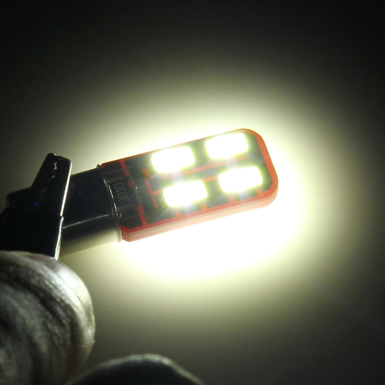 Glowing BA9S LED car clearance bulb with red PCB and six white SMD LEDs
