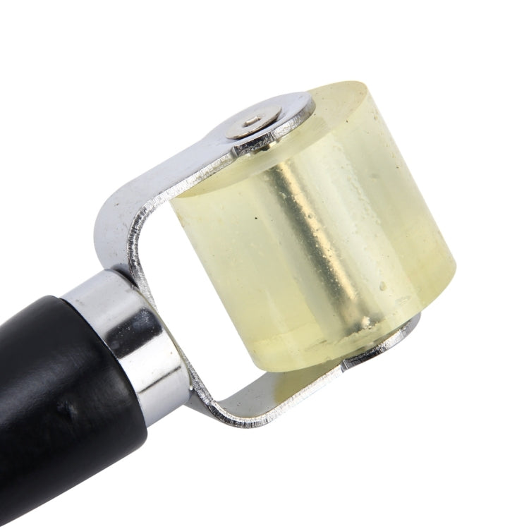 Car window film roller scraper tool close-up: black handle, yellow roller, silver metal frame