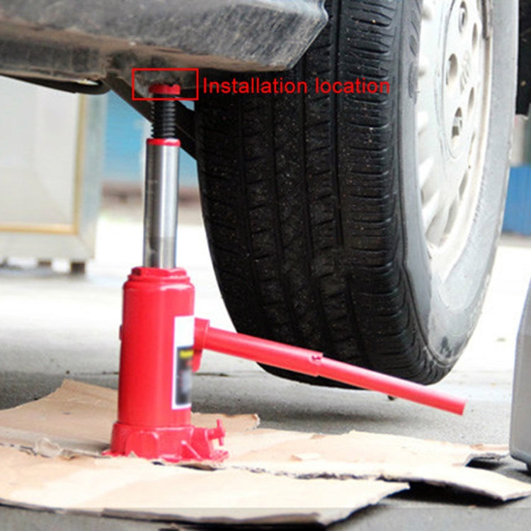 Black jack point support pad installed under car near red jack lift point
