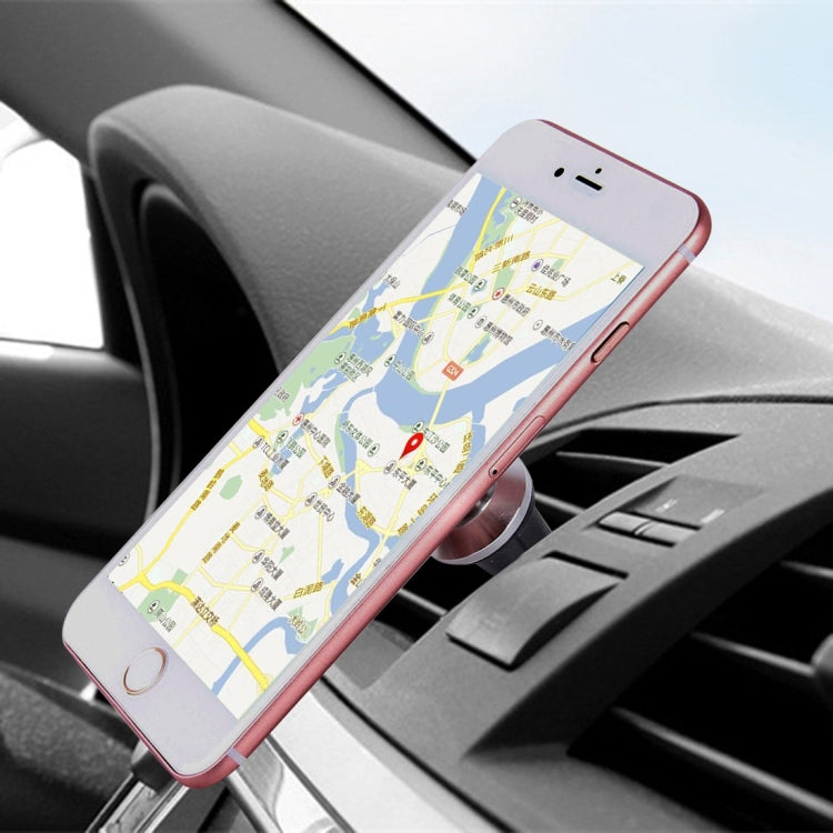 Dashboard car phone mount holding a rose-pink smartphone with navigation screen