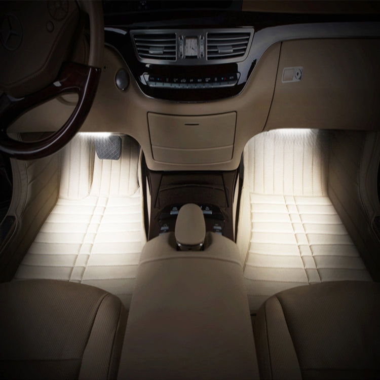 Vehicle interior with bright white light strips lighting the footwell area