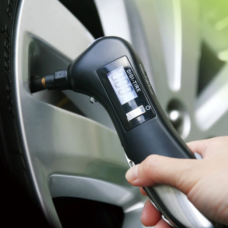 Black car flashlight tool plugged into cigarette lighter socket, hand holding