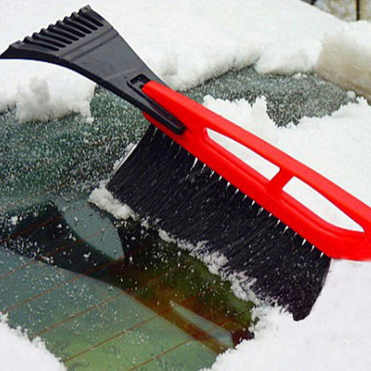 2-in-1 car snow shovel with red handle, black scraper and brush on icy surface