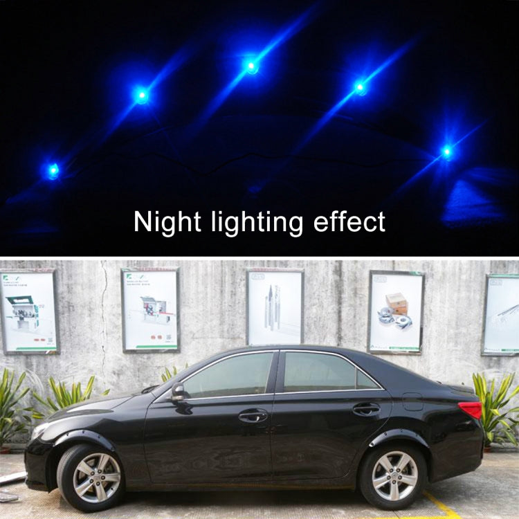 Car with black wheel arch fender flare decals showing blue glow at night