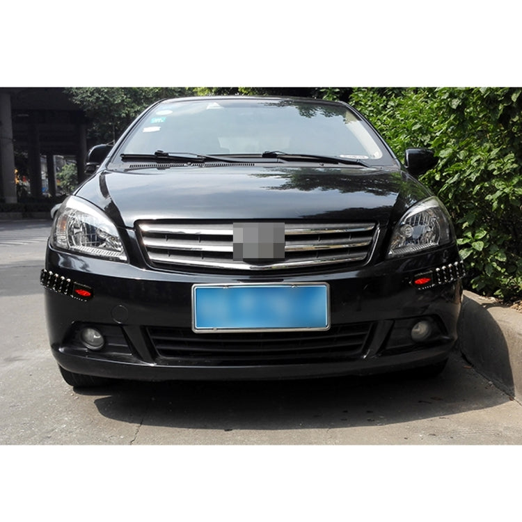 Black 4-piece bumper guard strip set with red reflector pads mounted on front.
