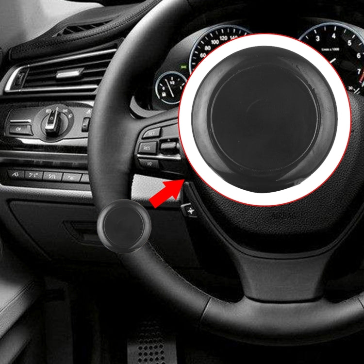 Black round steering wheel spinner knob accessory on the steering wheel spoke area.